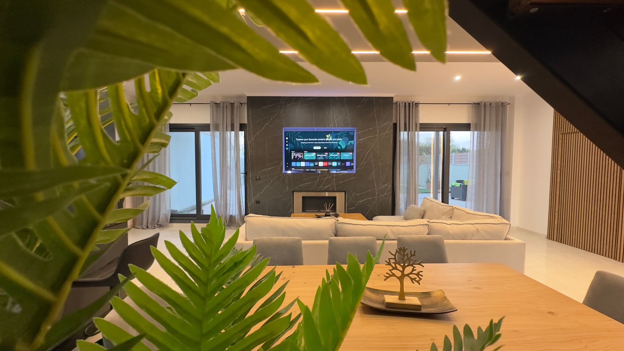 Living room with garden terrace views and warm natural light